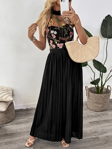 Detail of floral embroidery on lace halter neck jumpsuit with pleated long pants