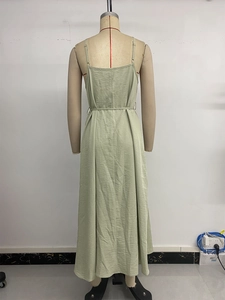Detail of adjustable straps and waist tie on a sage green linen summer maxi dress