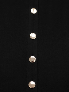 Macro detail of high-quality black fabric featuring four elegant gold metal round buttons