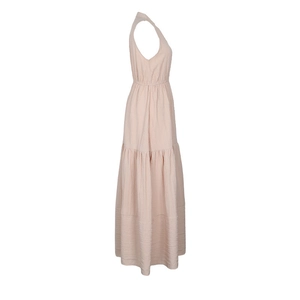Detail of light pink tiered sleeveless maxi dress with textured fabric and ruffled hem