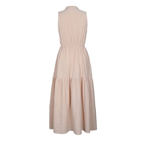 Detail of tiered long dress back showing elastic waist and textured fabric in pink