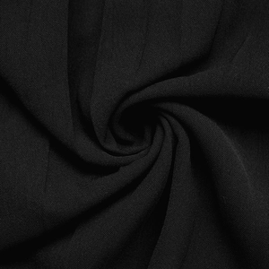 Close-up of black mesh fabric showing delicate lace embroidery and pleated texture