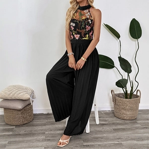 Women's black halter neck jumpsuit with floral lace embroidery and pleated wide legs
