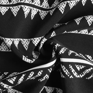 Close-up of black and white geometric tribal pattern fabric with soft flowing texture