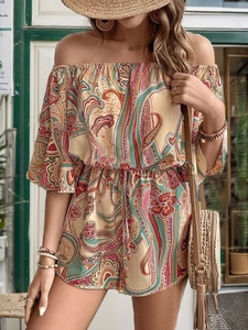 Detail of bohemian paisley print romper with elastic waist and ruffled sleeves in sunlight