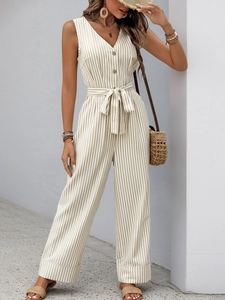 Detail of striped sleeveless jumpsuit with deep V-neck, button front and waist tie