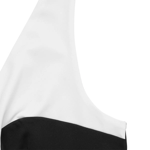 Makro-Detail der hochwertigen schwarz-weißen Kontrastnähte an einem V-Ausschnitt-Jumpsuit