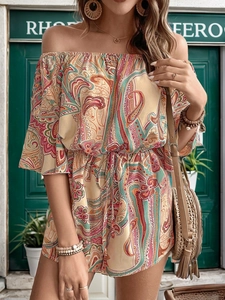 Detail of bohemian paisley print romper with off-shoulder neckline and drawstring waist