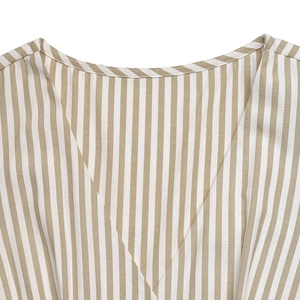 Detail of V-neckline on khaki striped sleeveless jumpsuit showing cotton fabric texture