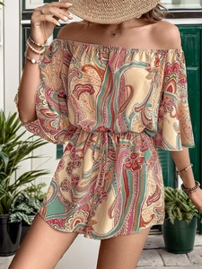 Detail of bohemian paisley print romper featuring off-shoulder neckline and drawstring waist