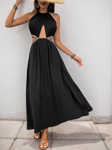 Détails de broderie et découpes à la taille sur une robe longue noire sans manches
