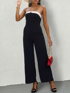Detail of elegant black and white color block tube jumpsuit with wide leg design