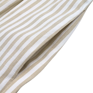 Detail of side pockets on beige and white striped sleeveless jumpsuit in soft fabric