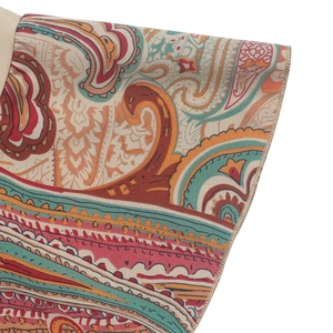 Detailed macro view of bohemian paisley print fabric with high-quality edge stitching