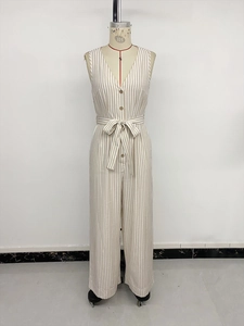Detailed view of the V-neck stripe jumpsuit with wooden buttons and a tie-waist belt