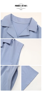 Detail view of light blue jumpsuit with lapel collar, side pockets and textured fabric