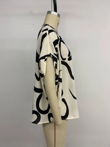 Side view of white sleeveless blouse with black abstract geometric print for women