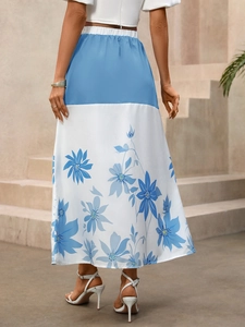 Rear view of high waist blue and white floral A-line maxi skirt on female model