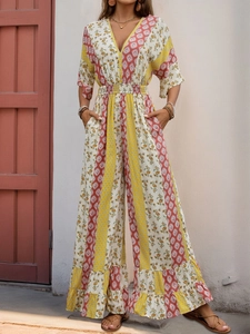 Detail of bohemian floral wide leg jumpsuit with V-neck and ruffled hem in natural light