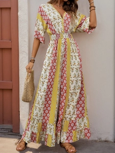 Detail of bohemian floral print jumpsuit with V-neckline and elastic high waist design