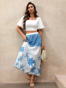 Close-up of floral print long skirt featuring blue flower patterns and high waist details