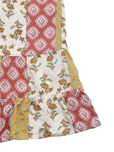 Close-up of bohemian patchwork print with floral patterns and ruffled hem detail