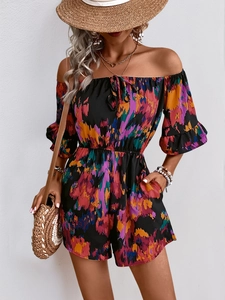 Detail of off-shoulder floral romper with ruffle sleeves and abstract colorful print