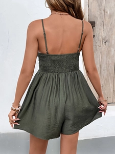 Detail of smocked elastic back on olive green summer jumpsuit with thin straps