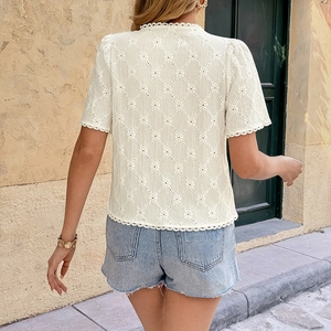 White eyelet short sleeve blouse with lace trim shown from back view on a model