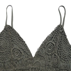 Detail of army green lace romper featuring boho mandala crochet patterns and V-neckline