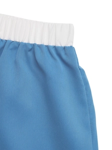 Detail of high-elastic white waistband on lake blue printed A-line skirt fabric