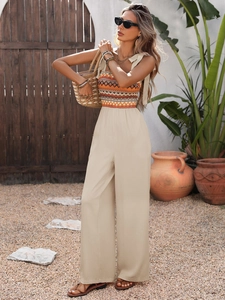 Summer ethnic print jumpsuit with tie-straps and wide-leg beige pants for vacation