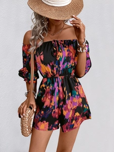 Detail of off-shoulder floral romper featuring drawstring bow and ruffled sleeves