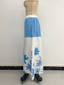 Detail of the elastic waistband and floral print pattern on the blue and white long skirt