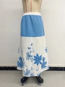 Detail of high waist elastic band and blue floral print on A-line maxi skirt