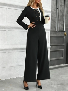 Outdoor street view of a wide-leg jumpsuit with gold buttons and contrast white collar