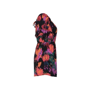 Detail of vibrant abstract print and ruffled flutter sleeves on a summer jumpsuit