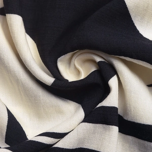 Detail shot of black and white striped textile fabric showing soft texture and drape