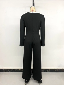 Detail of elegant black long sleeve jumpsuit showing back waistline and wide leg fit