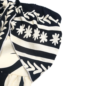 Close-up of ethnic print fabric showing detailed floral patterns and quality stitching