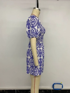 Detail view of ethnic blue floral print on smocked square neck bubble sleeve romper