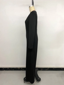 Side view of elegant black long-sleeve jumpsuit showing high-waisted slimming fit