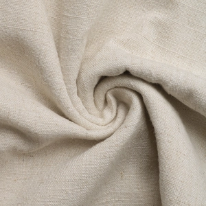 Close-up of the natural beige linen fabric texture with visible fiber grains and soft drape