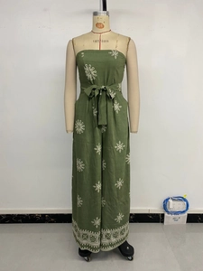 Detail of olive green tube jumpsuit with white mandala print and a tied waist belt