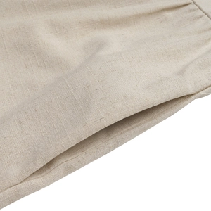 Detail of the oatmeal linen fabric texture with side pocket and pleated waist design