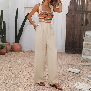 Bohemian jumpsuit with geometric print top and beige wide-leg trousers for summer style