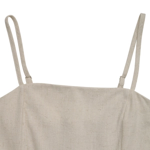Detail of adjustable thin straps and square neckline on beige linen blend jumpsuit