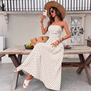 Summer strapless polka dot maxi dress with shirred waist in a stylish resort vacation setting