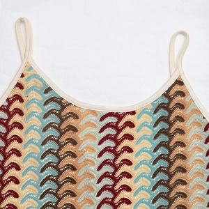 Detailed close-up of Bohemian zigzag knit pattern and strap on a multicolor dress