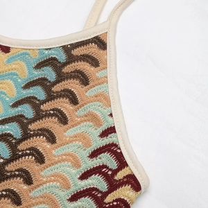 Close-up of bohemian crochet knit fabric with colorful wave patterns and fine stitching